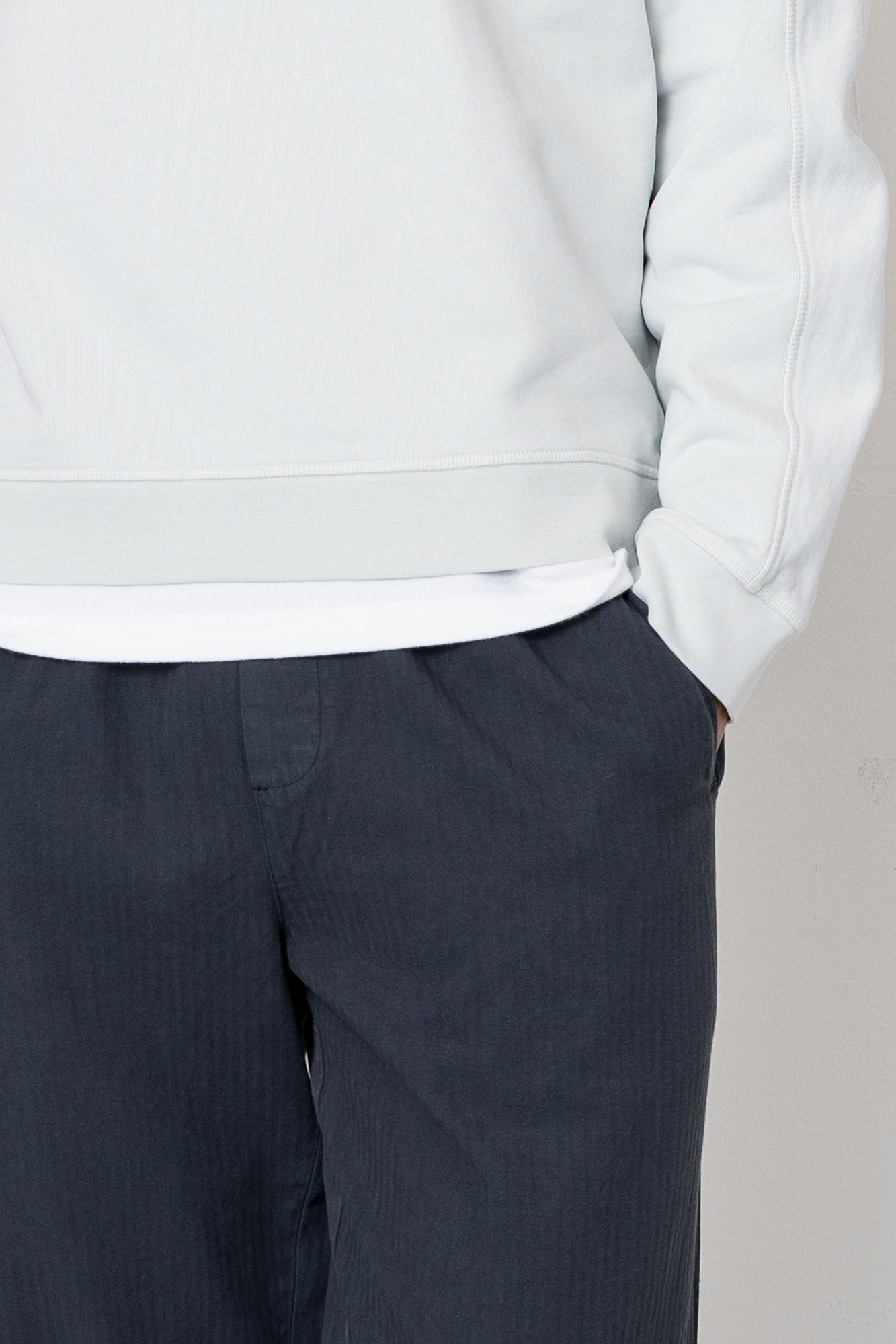 Light gray hoodie and dark gray pants on a neutral background