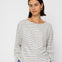 Woman wearing a striped shirt and blue jeans against a white background