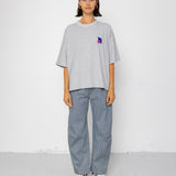 Person wearing a gray oversized t-shirt and pants on a white background