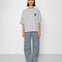 Person wearing a gray oversized t-shirt and pants on a white background