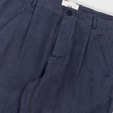 Navy blue pleated pants with a brand label on a white background