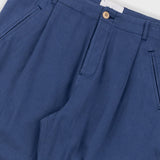 Close-up of blue pants with a button on a white background