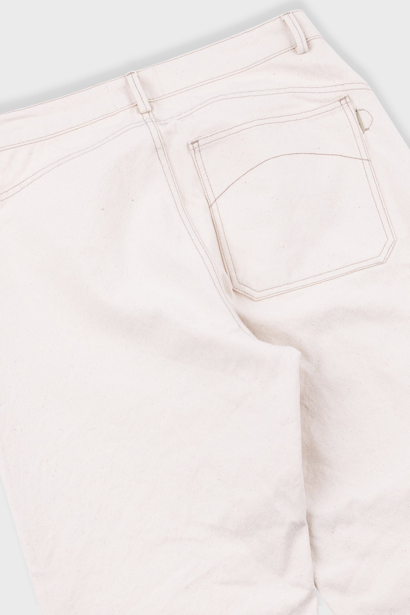 Close-up of white jeans on a white background