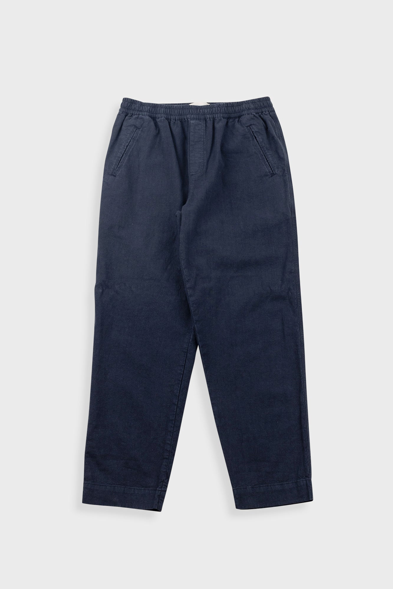 Navy blue pants on a light gray background