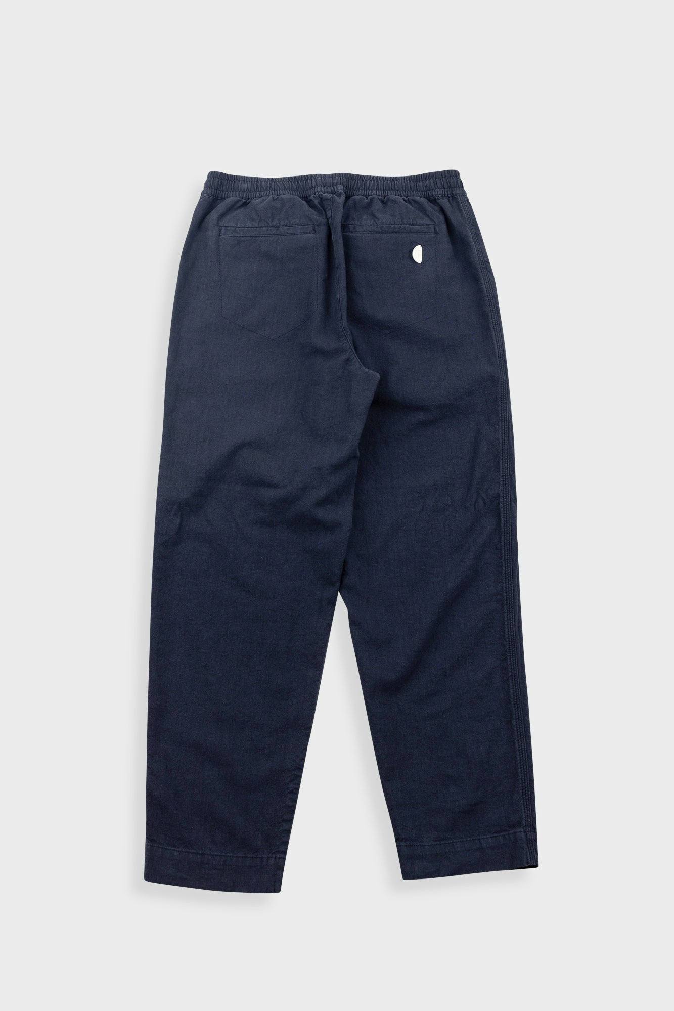Navy blue pants on a light gray background