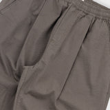 Close-up of brown pants with a white background