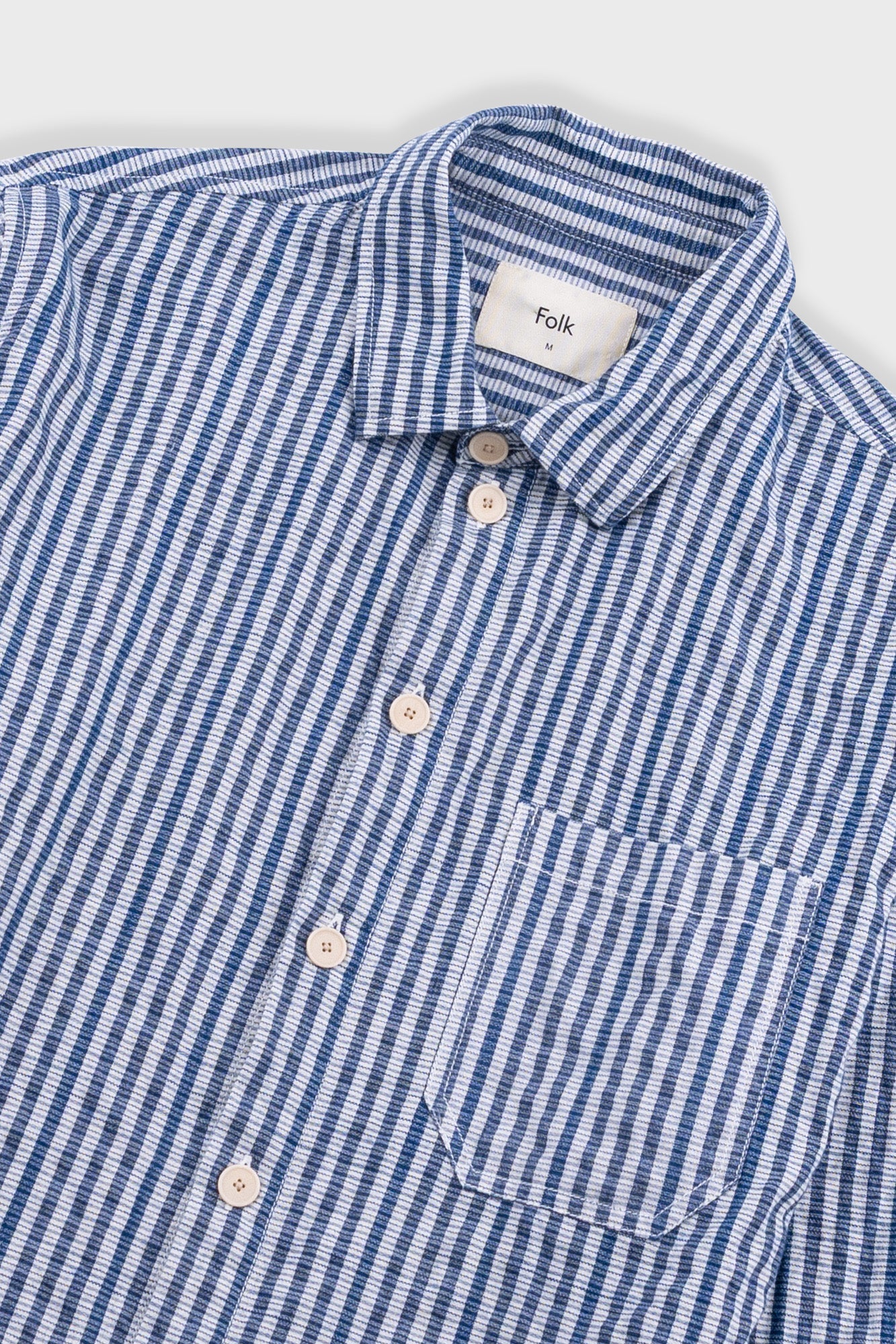 Blue and white checkered shirt with 'folk' label on a white background