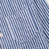 Close-up of a blue and white striped shirt with buttons.