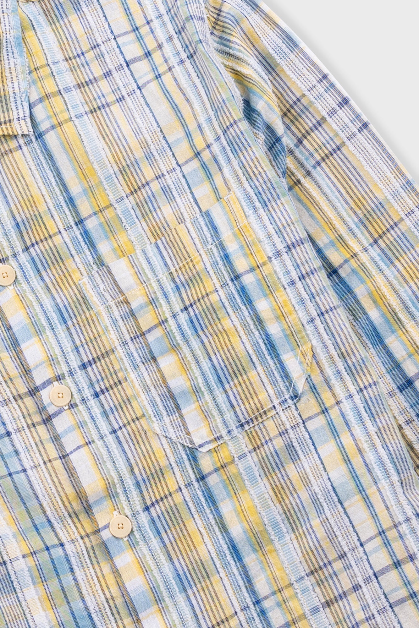 Close-up of a plaid shirt with blue and yellow pattern