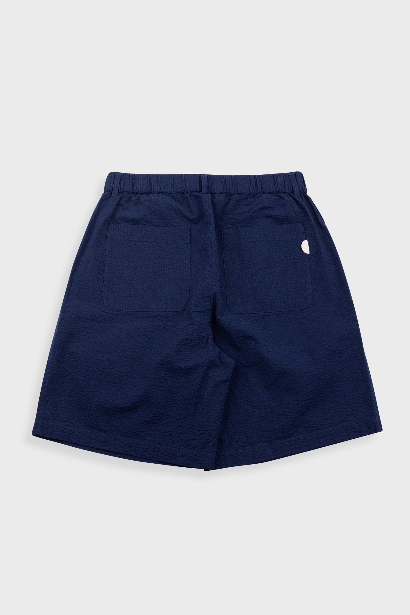 Navy blue shorts on a light gray background