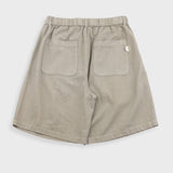 Beige shorts with button on a white background