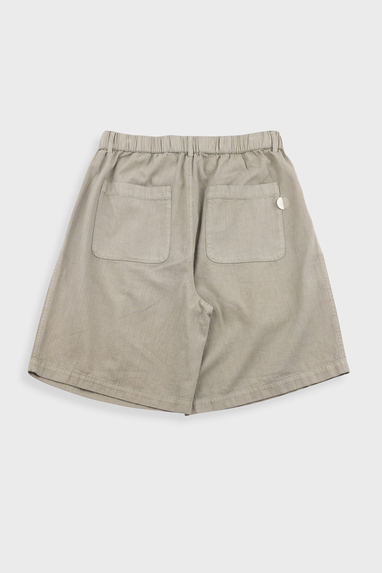 Beige shorts with button on a white background