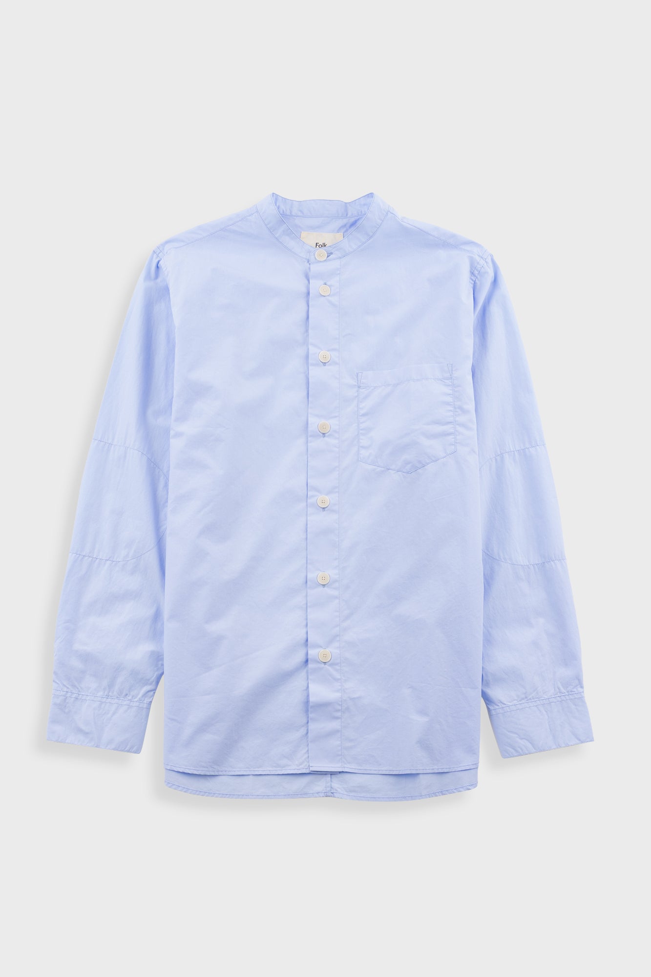 Light blue button-up shirt on a light gray background