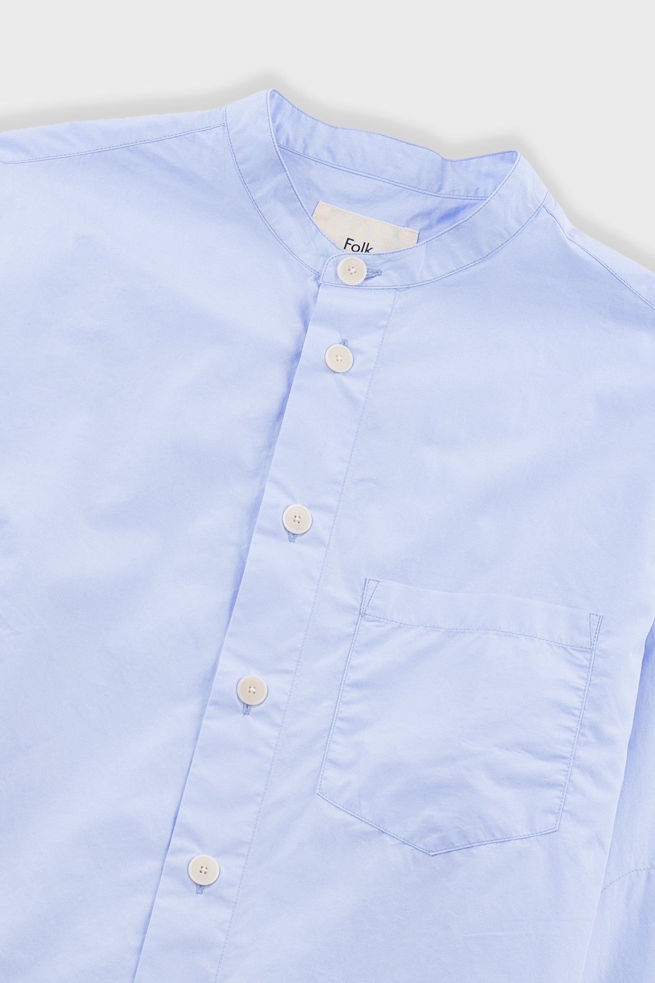 Blue shirt on light grey background