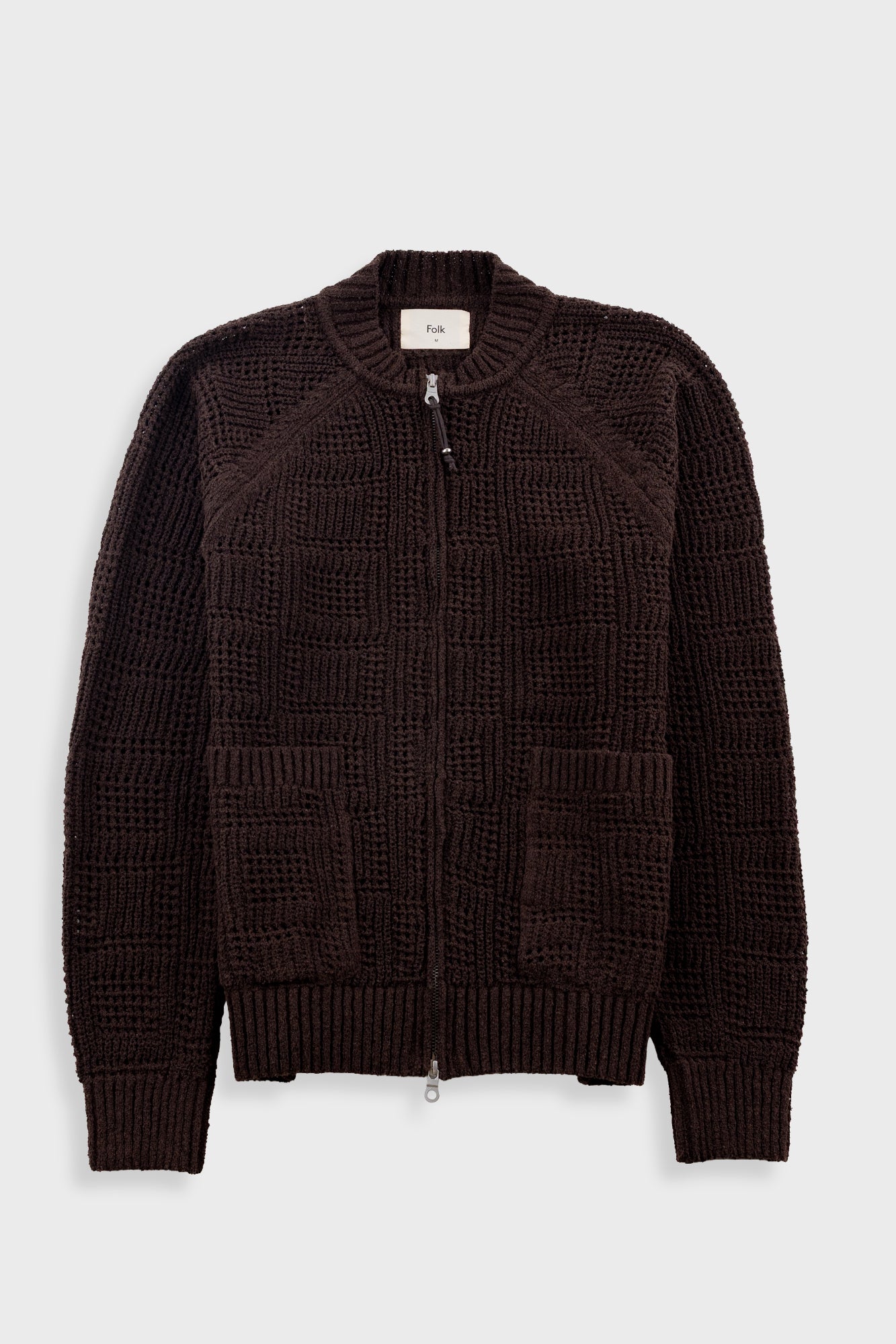 Dark brown textured sweater on a light gray background