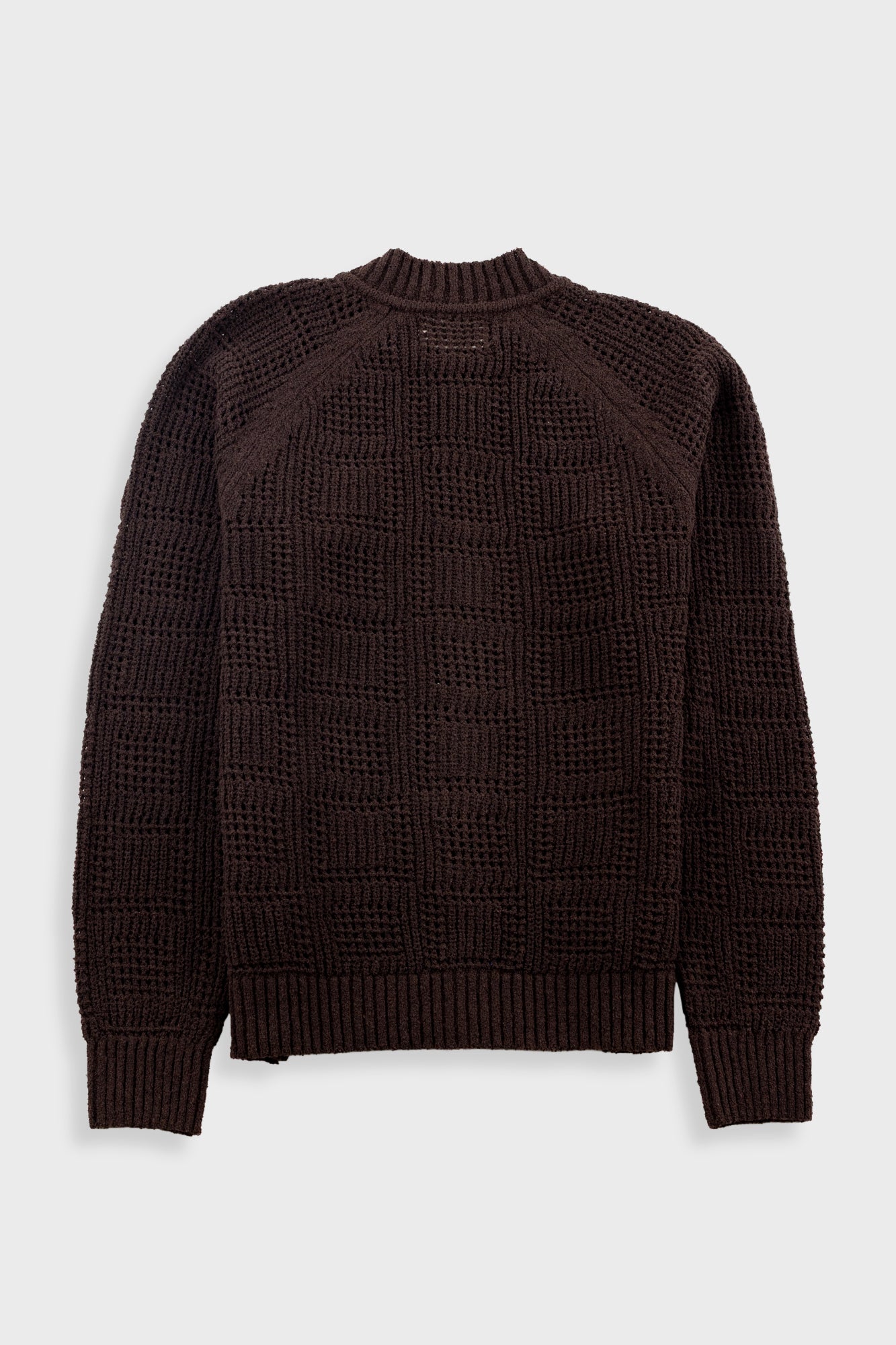 Dark brown textured sweater on a light gray background