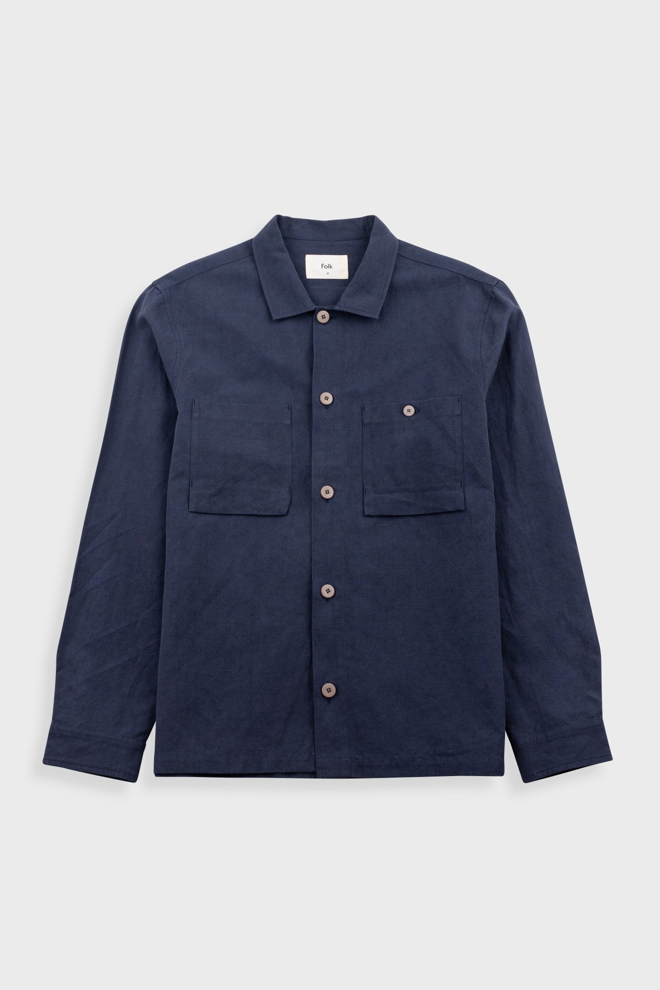 Navy blue jacket with button details on a light gray background