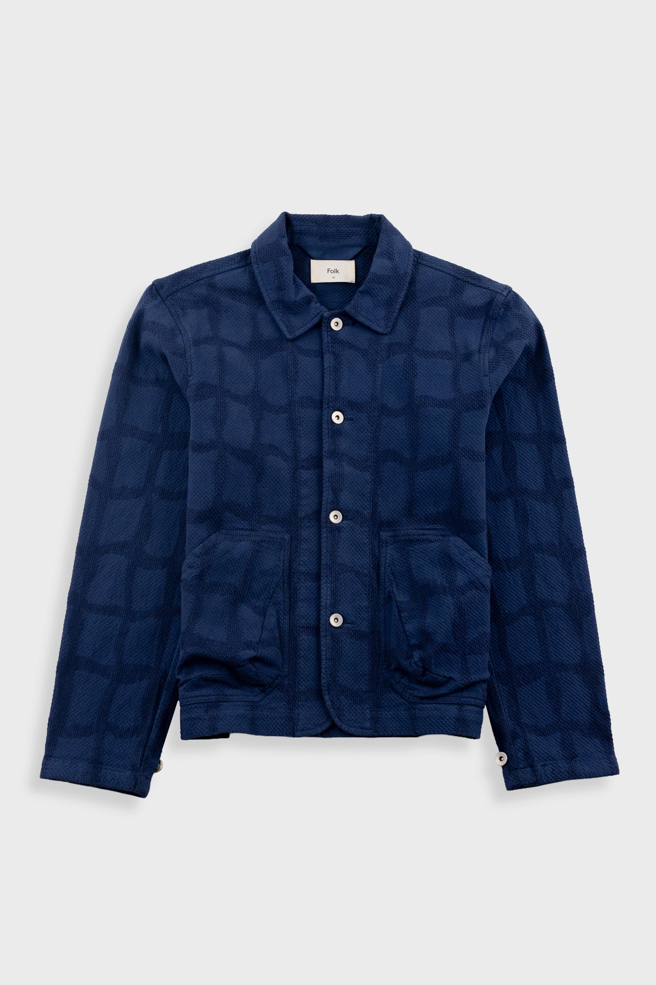 Navy blue checkered jacket on a light gray background