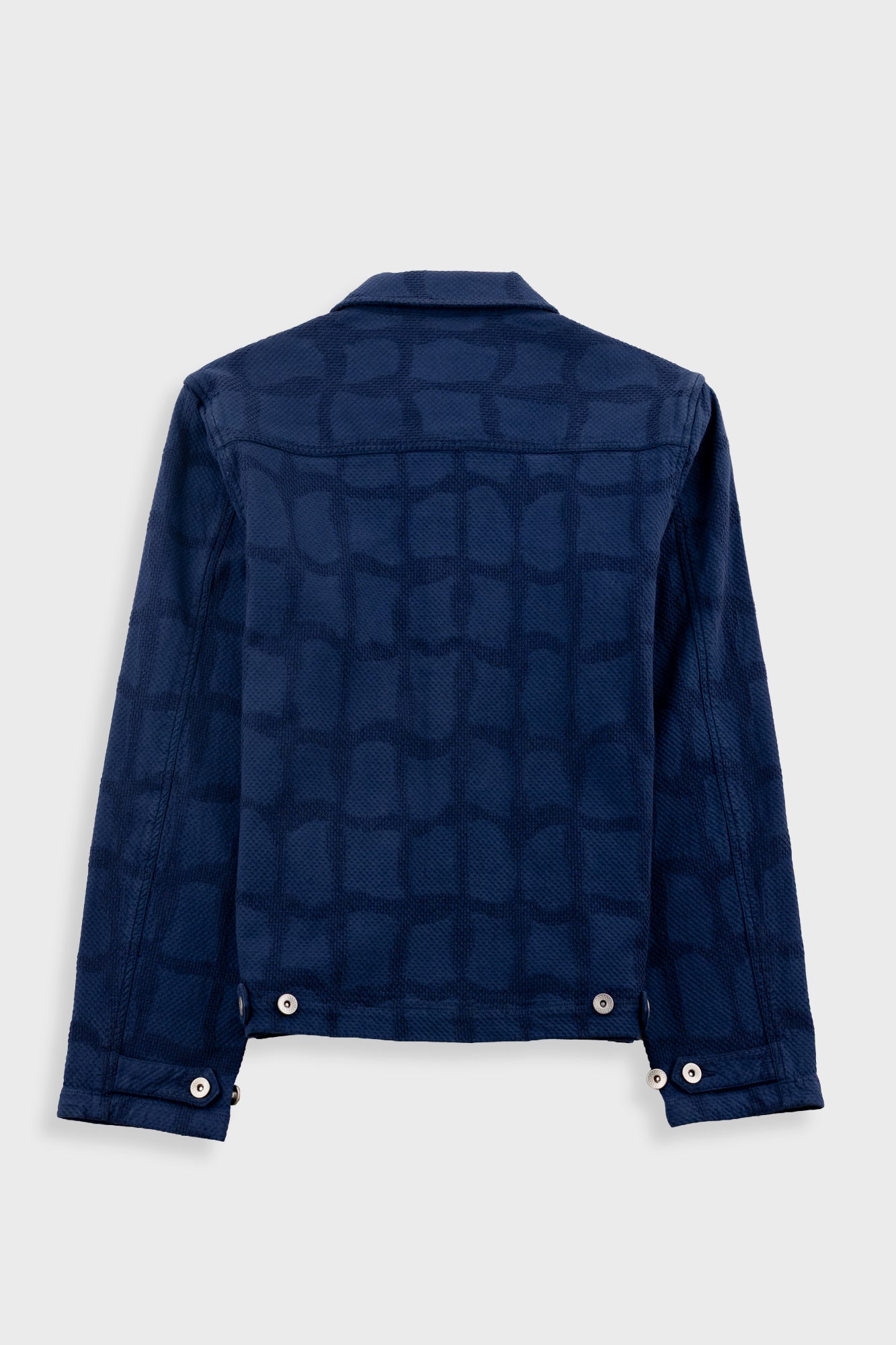 Blue denim jacket with a geometric pattern on a white background