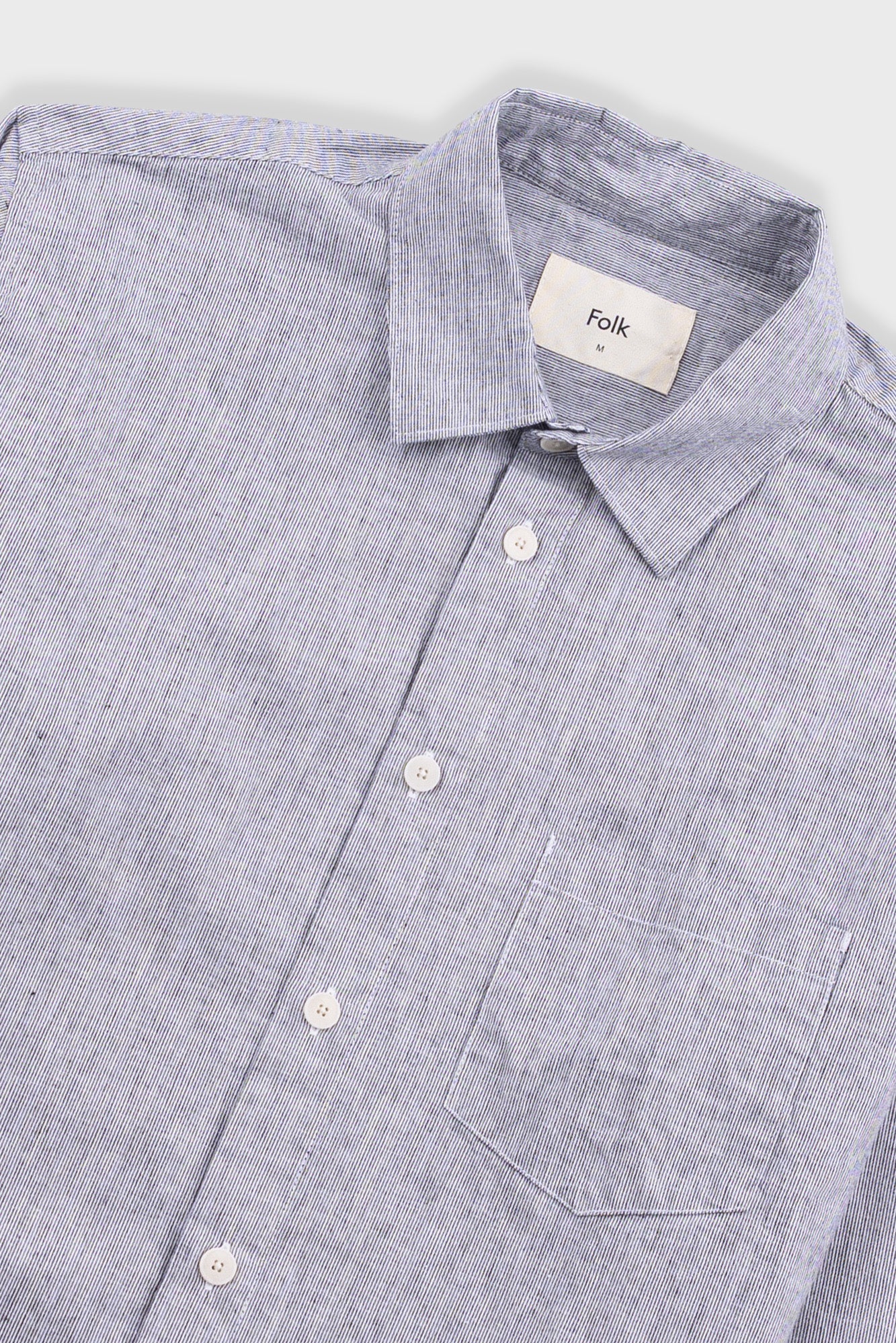 Gray button-up shirt with 'Folk' label on a light gray background