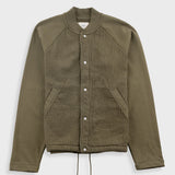 Green jacket with button details on a white background