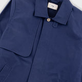 Navy blue coat with a brand label on a light gray background