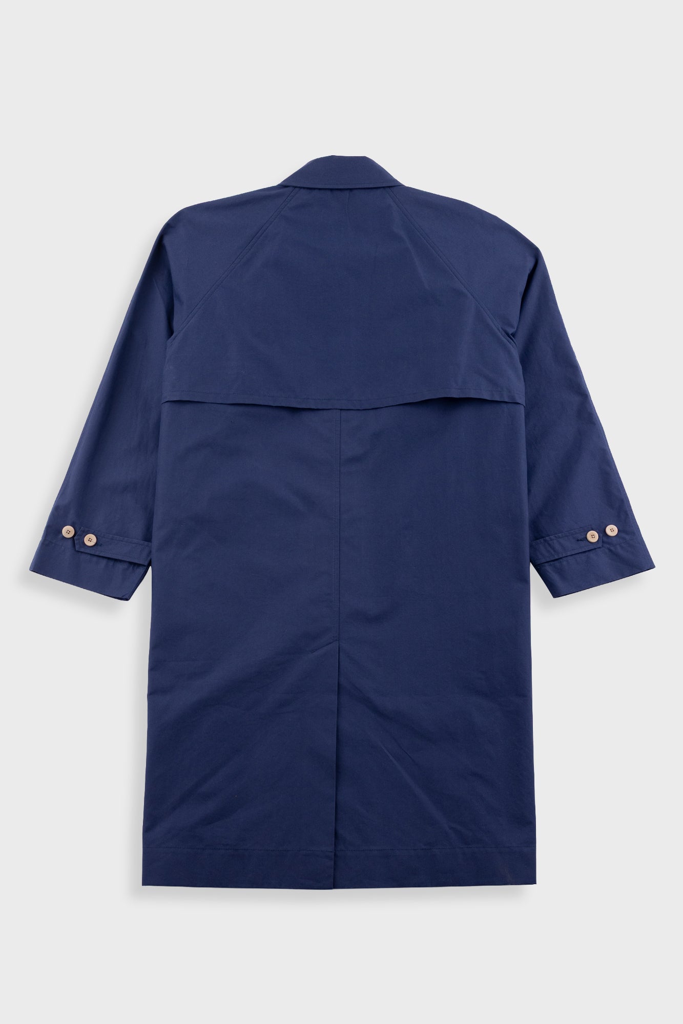 Navy blue trench coat on a light gray background
