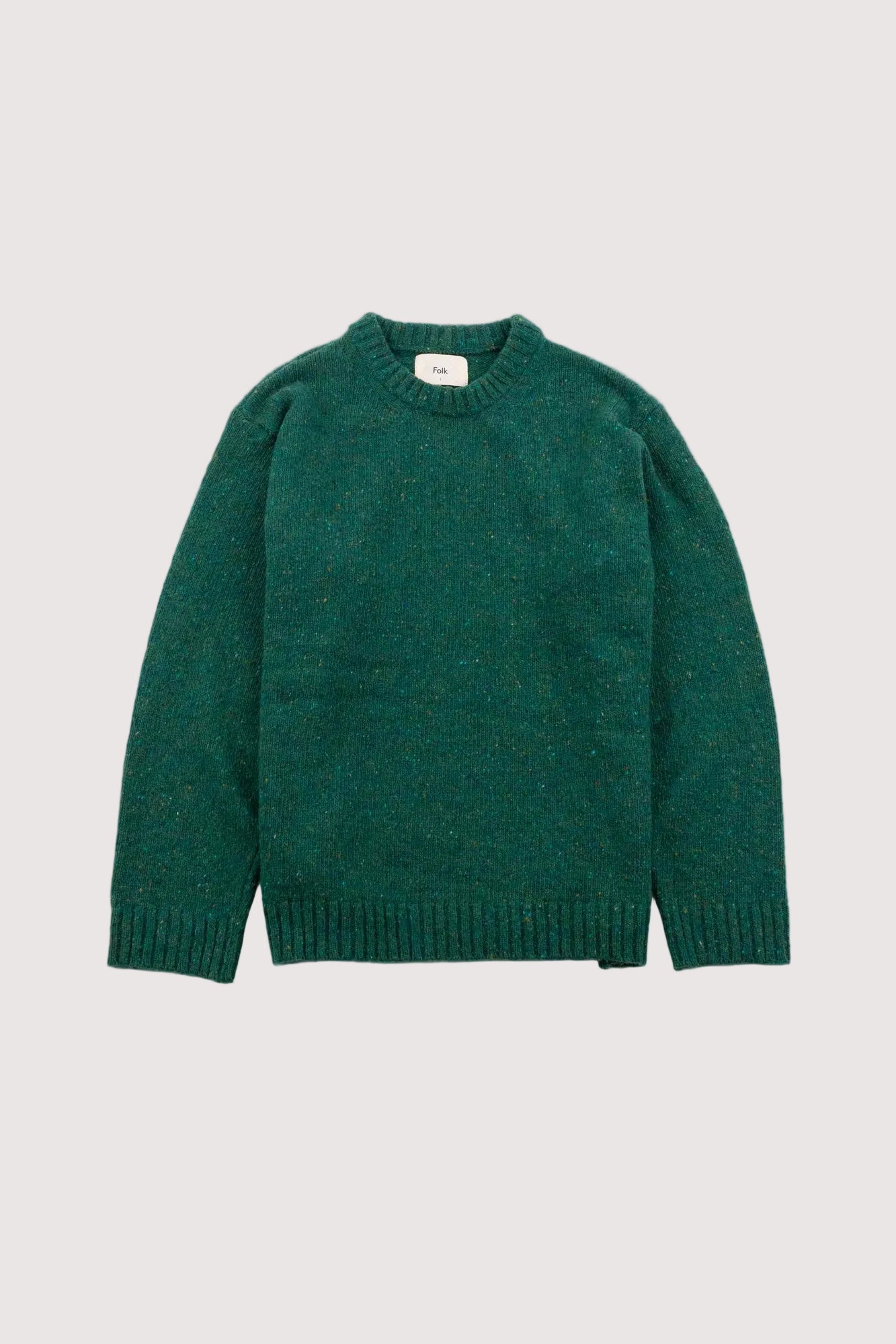 Green sweater on a light gray background