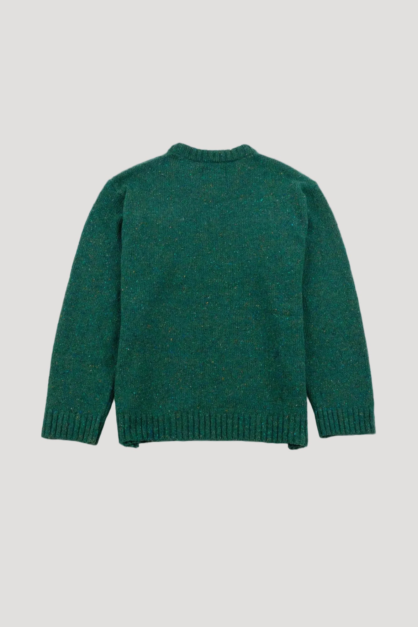 Green knitted sweater on a light gray background