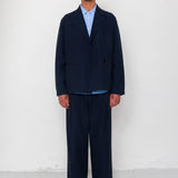 Man wearing a navy suit against a white background