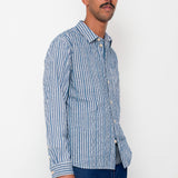 Man wearing a blue and white striped shirt against a white background