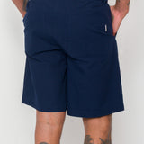 Navy shorts worn by a person on a white background