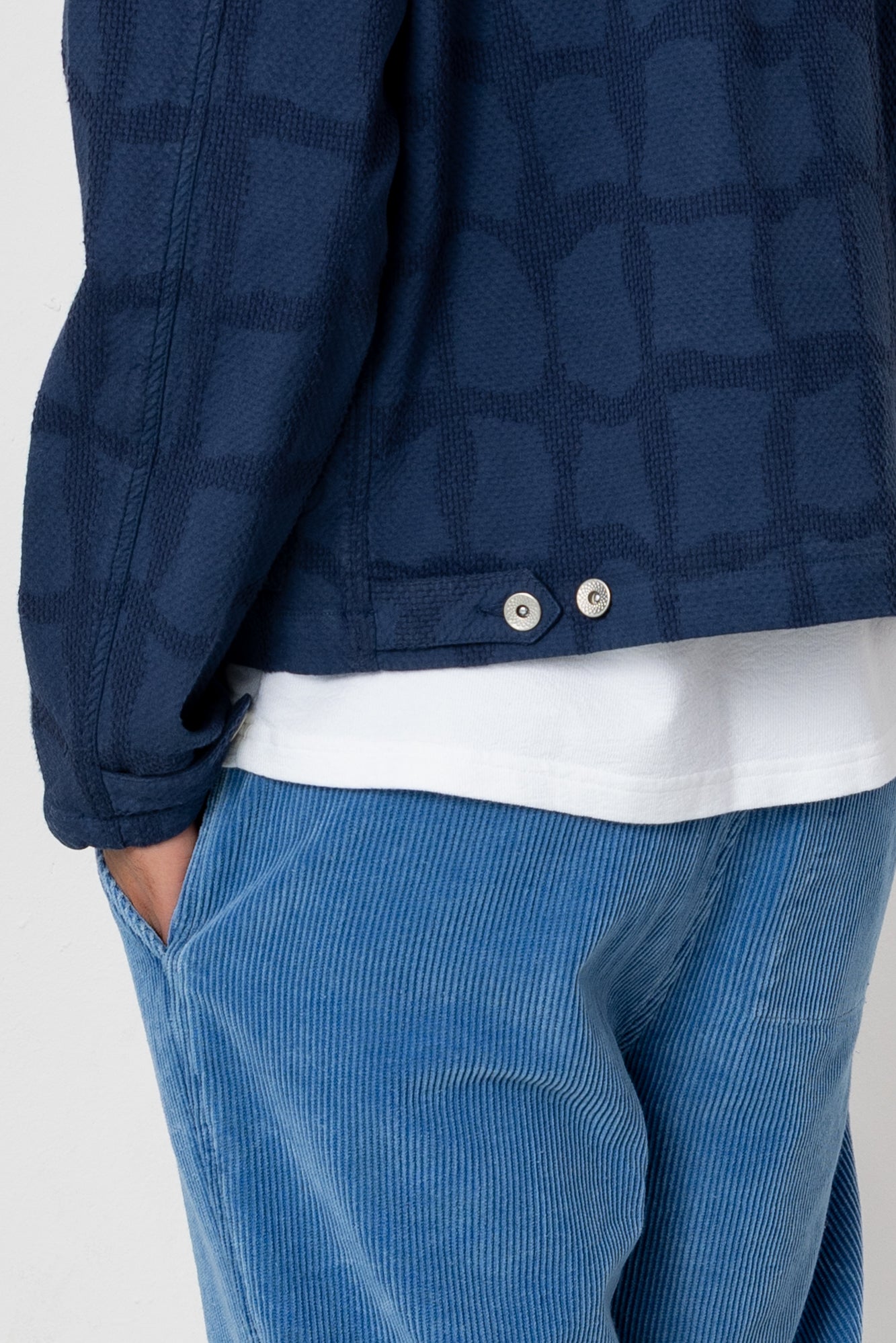 Man wearing a navy blue jacket against a white background