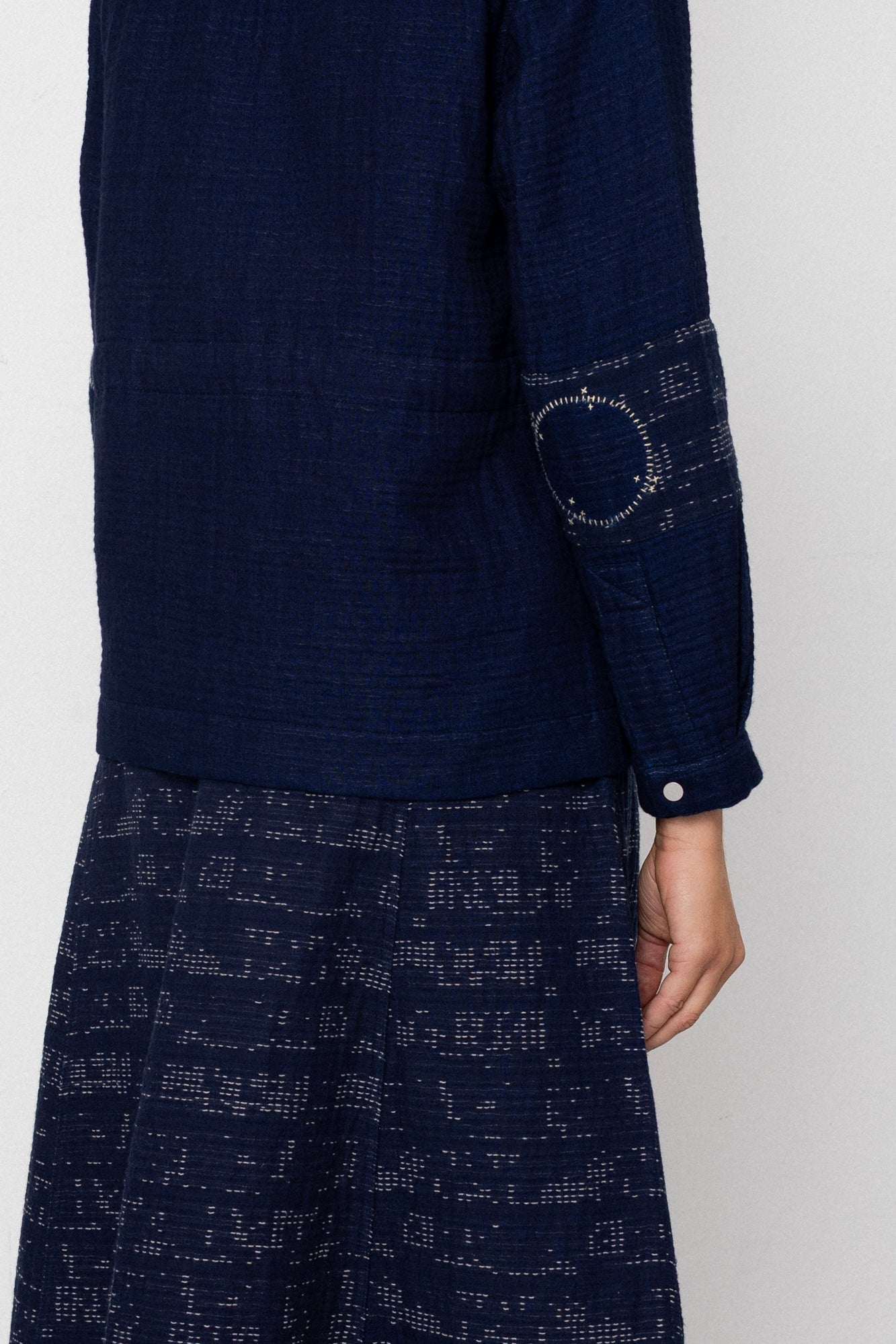 Navy blue patterned outfit on a plain background