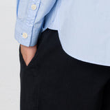 Close up of button detail on light blue shirt