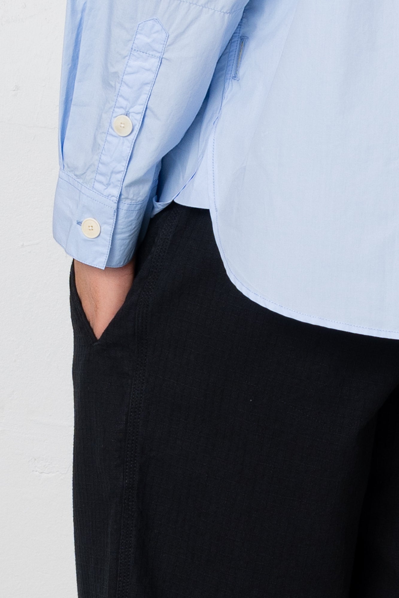 Close up of button detail on light blue shirt