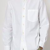 White button-up shirt worn by a person on a plain background