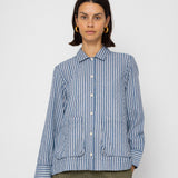 Person wearing a blue and white striped shirt against a white background