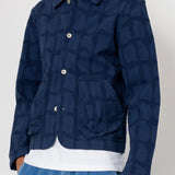 Person wearing a blue patterned jacket on a white background