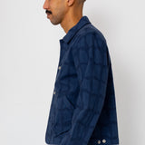 Man wearing a navy blue jacket against a white background