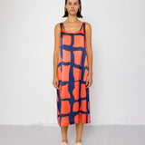 Woman wearing a patterned dress against a white background