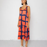 Woman wearing a patterned dress against a white background