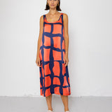 Woman wearing a red and blue patterned dress on a white background