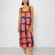 Woman wearing a sleeveless dress with a geometric pattern on a white background