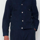 Navy blue jacket and pants worn by a person on a white background