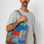 Man holding colourful dot print tote bag