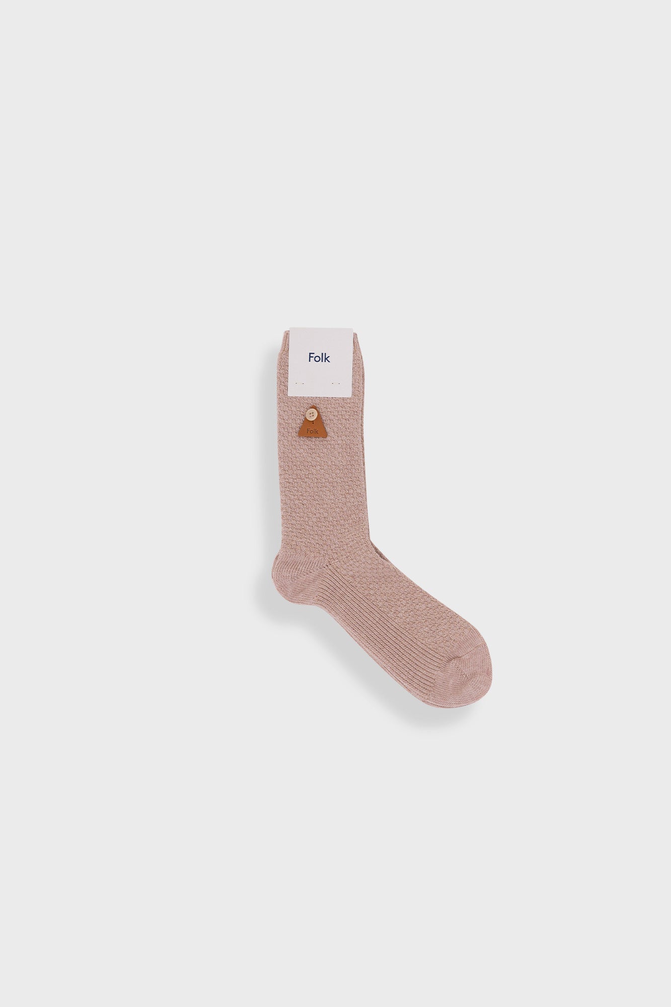 Beige sock with a label on a white background