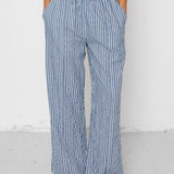 Person wearing blue and white striped pants on a white background