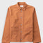 Orange cotton twill jacket laid flat against a light grey background