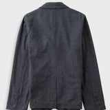 A dark charcoal gray wool blazer shown from the back, featuring a classic collar, long sleeves with button cuffs, and a clean silhouette on a light gray background.